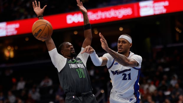 Washington Wizards center Daniel Gafford (21) passes the ball as Minnesota Timberwolves center Naz Reid (11) defends in the fourth quarter at Capital One Arena. Mandatory Credit: Geoff Burke-USA TODAY Sports